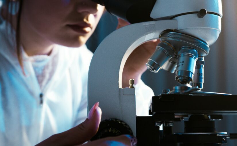 scientist viewing microscope