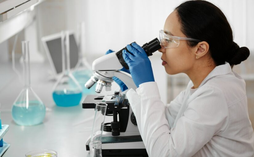 scientist looking in a microscope